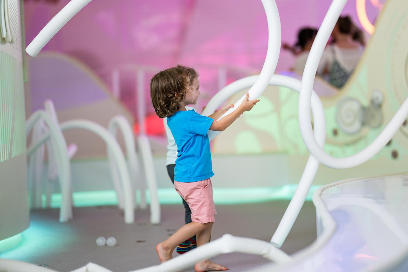A child playing with a hands-on exhibit at Terra