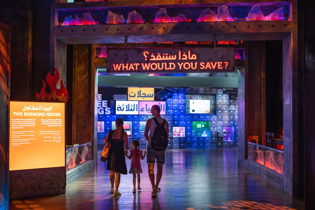 A family walking into the Burning House exhibit at Terra
